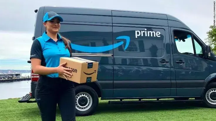 Delivery partner holding Amazon package